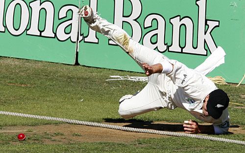 Matthew Bell dives over the rope in trying to save a boundary