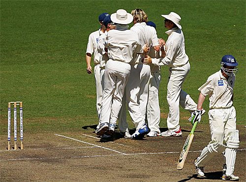 Nathan Bracken is mobbed after giving Lloyd Mash his marching orders