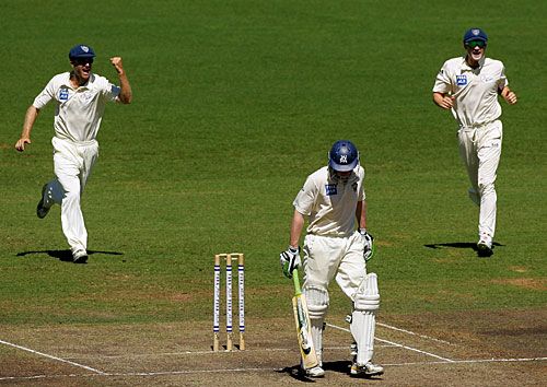Simon Katich and Michael Clarke rush in after Lloyd Mash's wicket
