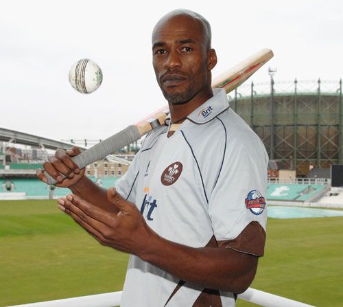 Chris Lewis poses after re-signing with Surrey