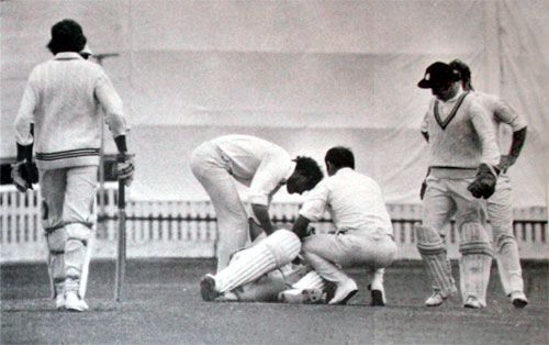 Mike Denness and John Edrich tend to the prone Ewen Chatfield