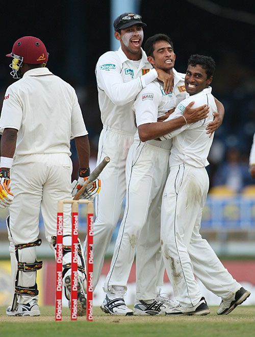 Ishara Amerasinghe is flanked by Michael Vandort and Chamara Silva after he dismissed Dwayne Bravo for 26