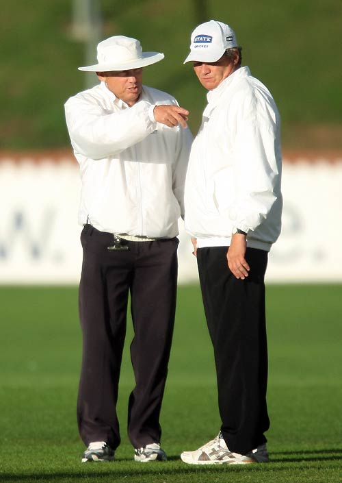 The umpires Barry Frost and Phil Jones are concerned about the light
