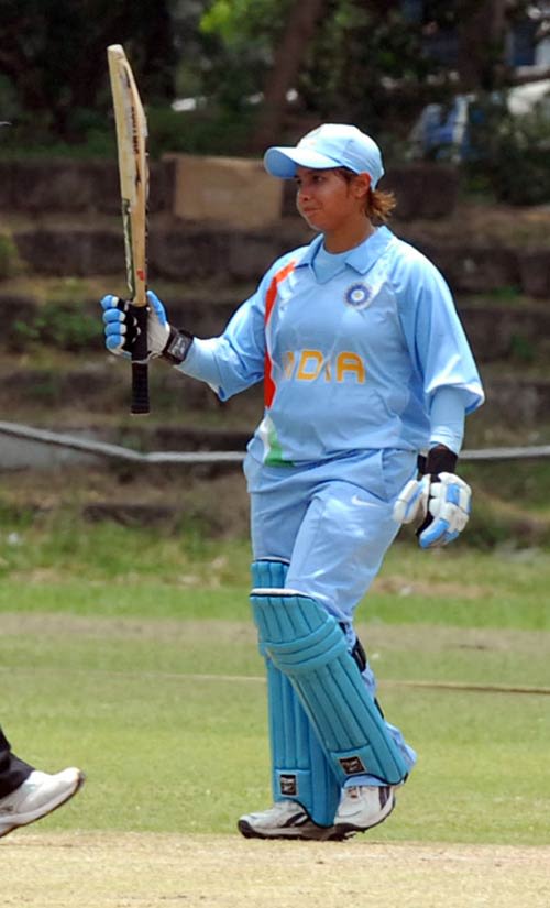 Jaya Sharma raises her bat after crossing fifty