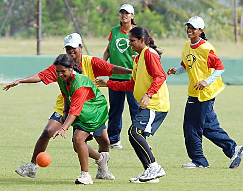 Karu Jain plays with a mini-basketball along with team-mates during practice