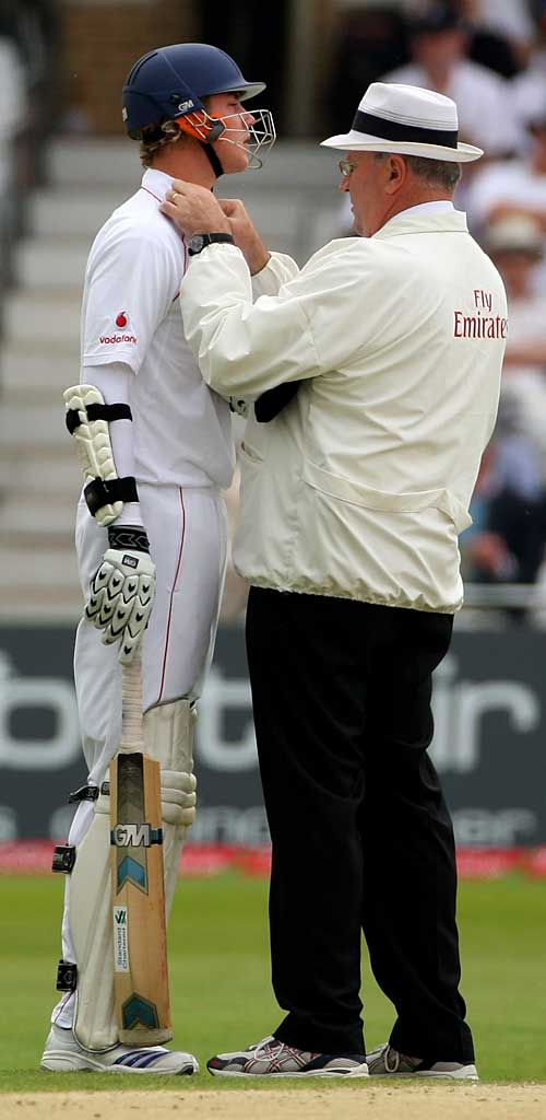 Darrell Hair helps Stuart Broad to cover an offending logo