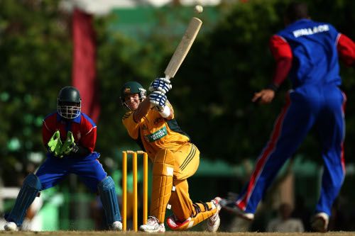 Shane Watson takes the aerial route against Gavin Wallace