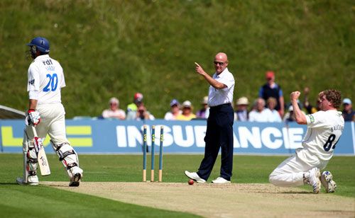 Jeff Evans raises his finger as David Balcombe celebrates running out Michael Yardy