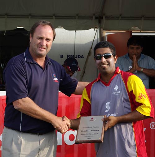 Karun Jethi receives the Man-of-the-Match award from Richard Done for his all-round show
