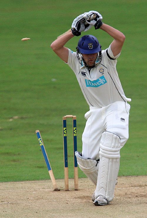 Chris Benham is clean bowled shouldering arms to Jade Dernbach