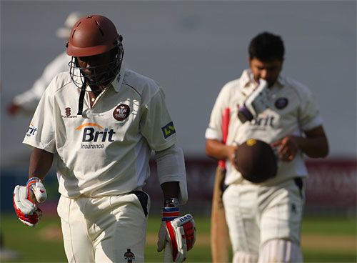 Pedro Collins and Usman Afzaal trudge off after Surrey's innings defeat