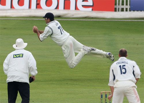 In and out: Justin Kemp spills a catch off Michael Di Venuto
