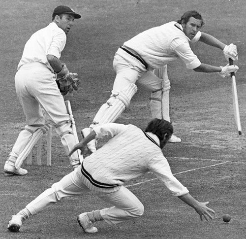 John Hampshire guides the ball past a diving Harry Latchman