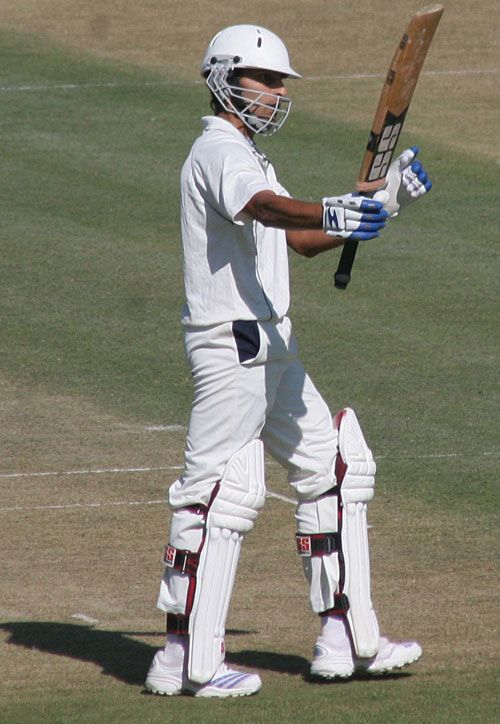 Sangram Singh raises his bat after scoring a double-hundred