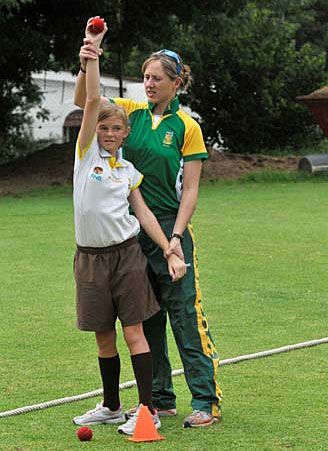 Cri-zelda Brits teaches a school girl how to bowl