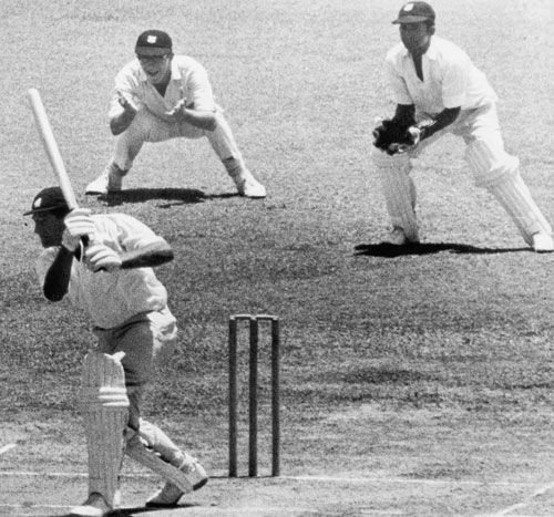Tony Lock drives during his brief stay at the crease