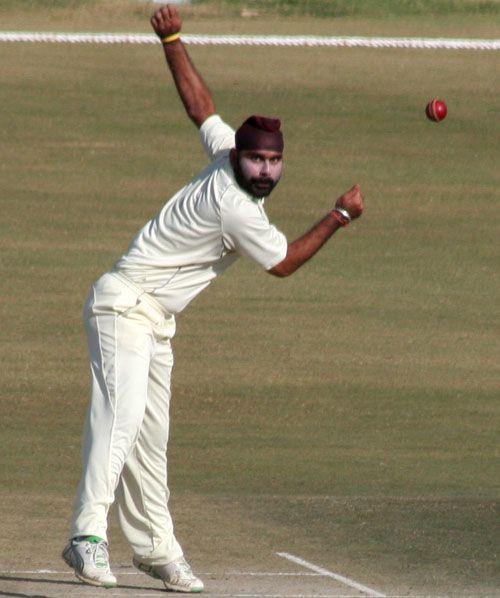 Himachal Pradesh offspinner Sarandeep Singh bowls