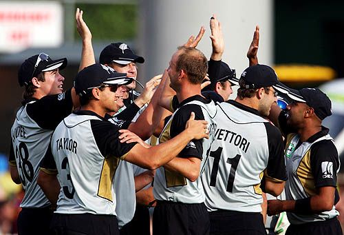 Ewen Thompson is congratulated on his first international wicket
