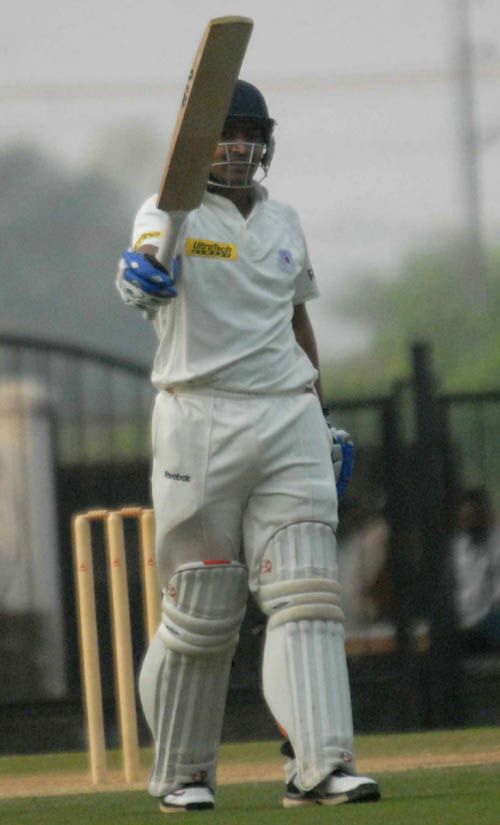 Shivakant Shukla raises his bat after reaching his century
