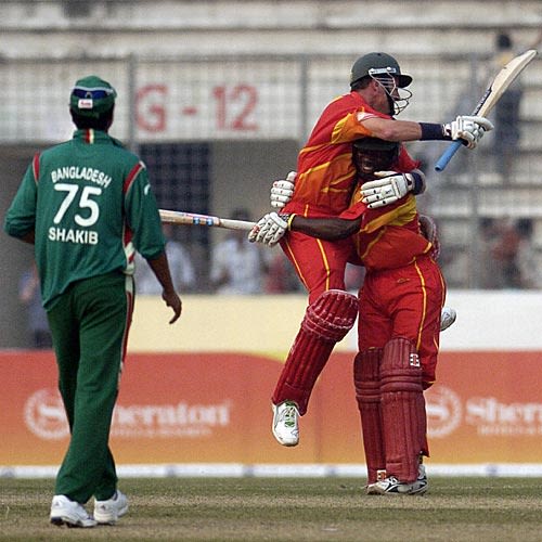 Ray Price and Tawanda Mupariwa celebrate Zimbabwe's win