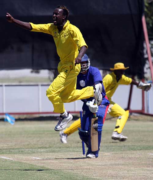 Kenneth Kamyuka jumps for joy as he collects one of his five wickets