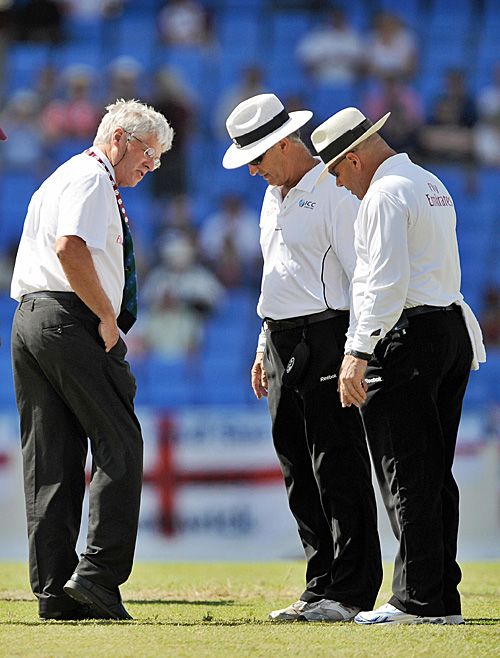 The match referee Alan Hurst inspects the pitch and run-ups with the two umpires, Daryl Harper and Tony Hill