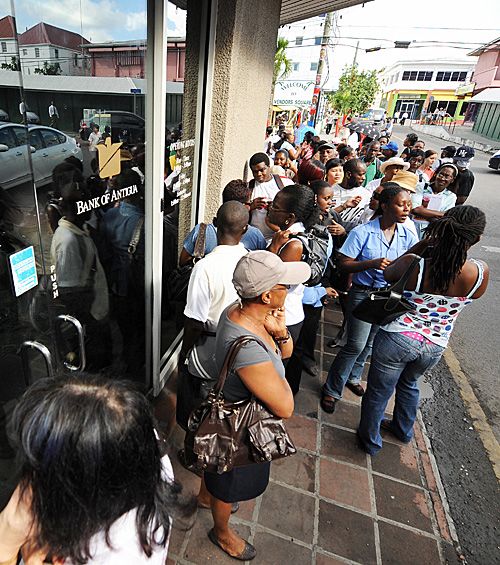 People queue outside a Bank of Antigua, owned by the Stanford Group, after it was revealed Allen Stanford was charged with fraud