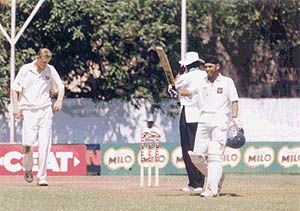 Ravneet Ricky waving his bat after his century