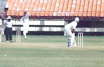 Tinu Youhanan is about to deliver the ball to JR Madanagopal