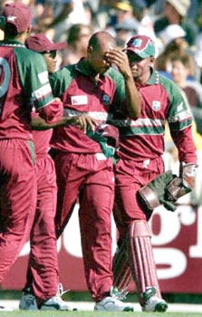 Williams comforted by teamates after injuring himself while trying for a catch