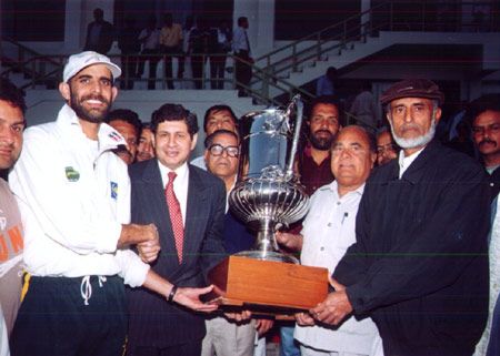 Captain of the winning team being presented the coveted trophy