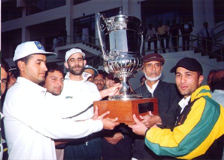 Players of the winning team with the trophy