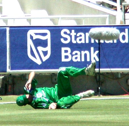 The Dolphins John Kent makes a valiant attempt to cut off a boundary