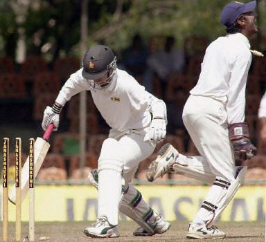 Zimbabwe batsman Given Rennie is seen being stumped by Wicket-keeper Sangakkara off the bowling by Muttiah Muralitharan