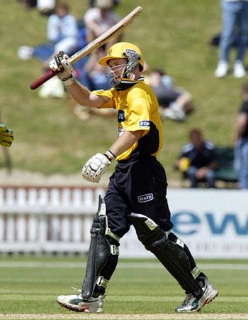 Nevin raises his bat to celebrate reaching his century. State Shield: Wellington v Canterbury at Wellington, 19 Jan 2003
