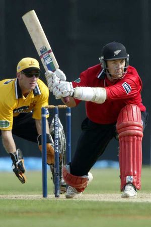 McMillan sweeps a delivery as Nevin looks on. State Shield: Wellington v Canterbury at Wellington, 19 Jan 2003