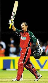Stuart Carlisle raises his bat after a well-paced hundred