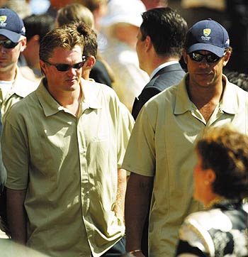 Andrew Symonds and Brad Williams make their way to the funeral service