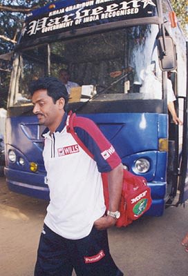 Raju alights from the bus on his way to the practice session