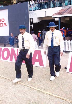 The umpires SK Tarapore and S Lakshmanan make their way into the middle
