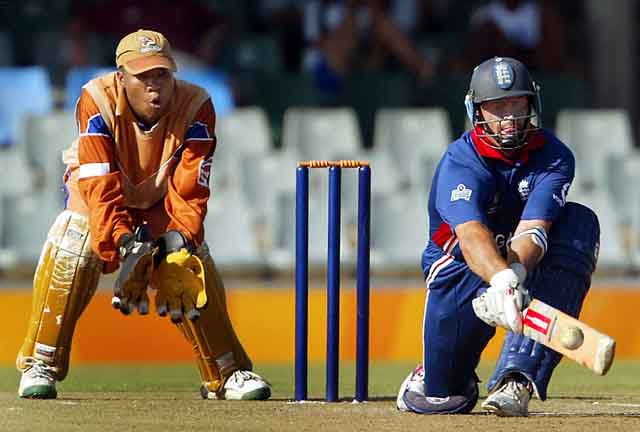 England's skipper Nasser Hussain reverse sweeps as Border Bears' wicket keeper Abongile Sodumo