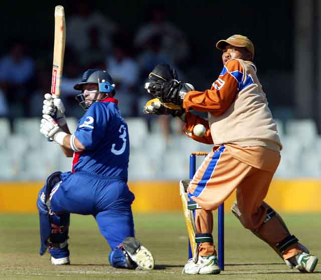 England's skipper Nasser Hussain sweeps behind as Border Bears' wicket keeper Abongile Sodumo