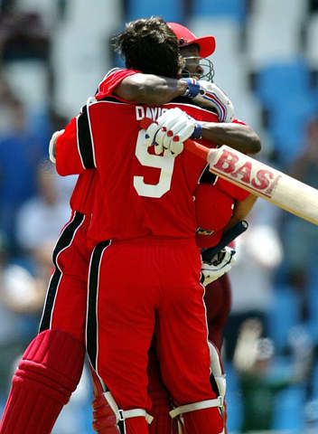 Team-mate Desmond Chumney hugs Davison following his scintillating hundred