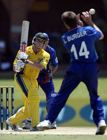 Matthew Hayden tries to hit the ball past Louis Burger