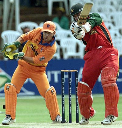 Jeroen Smits catches the edged ball off Zimbabwe batsman Craig Wishart
