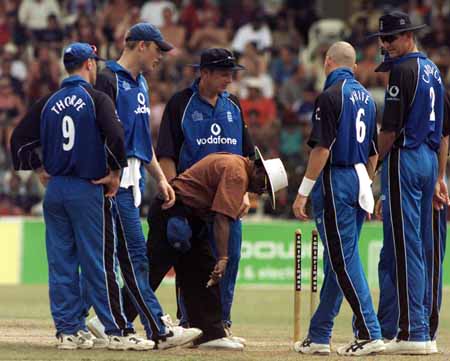 Umpire BC Cooray adds his skills to sorting out the stump camera problems