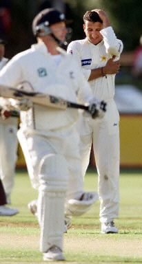 Fazl-e-Akbar holds his head after conceding four runs