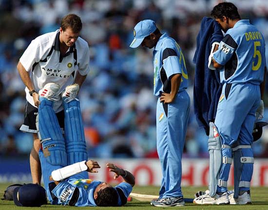 India's physiotherapist Andrew Leipus treats Sachin Tendulkar for cramps during his innings