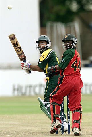 Tatenda Taibu watches the ball fly away from the bat of Saeed Anwar