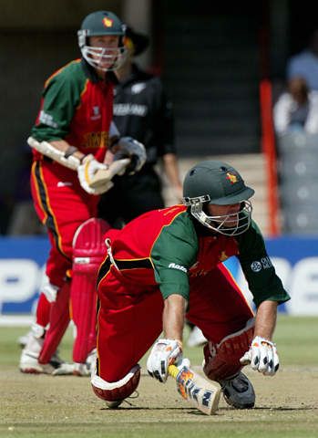 Whittall dives back to the crease in an attempted run out